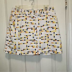 Slazenger golf skort size 8.  White w/ navy, orange and yellow print.